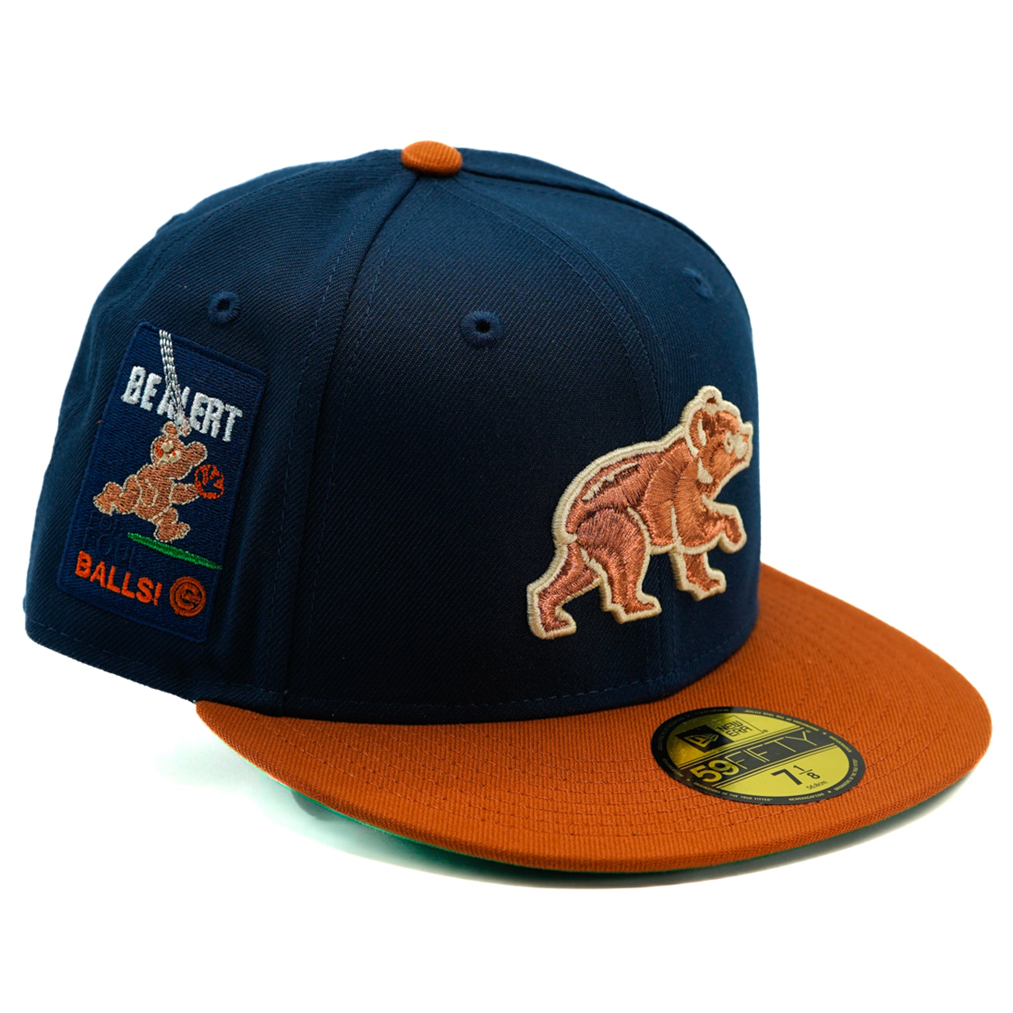 Navy and orange Chicago cubs cap with bear design and patch on a white background